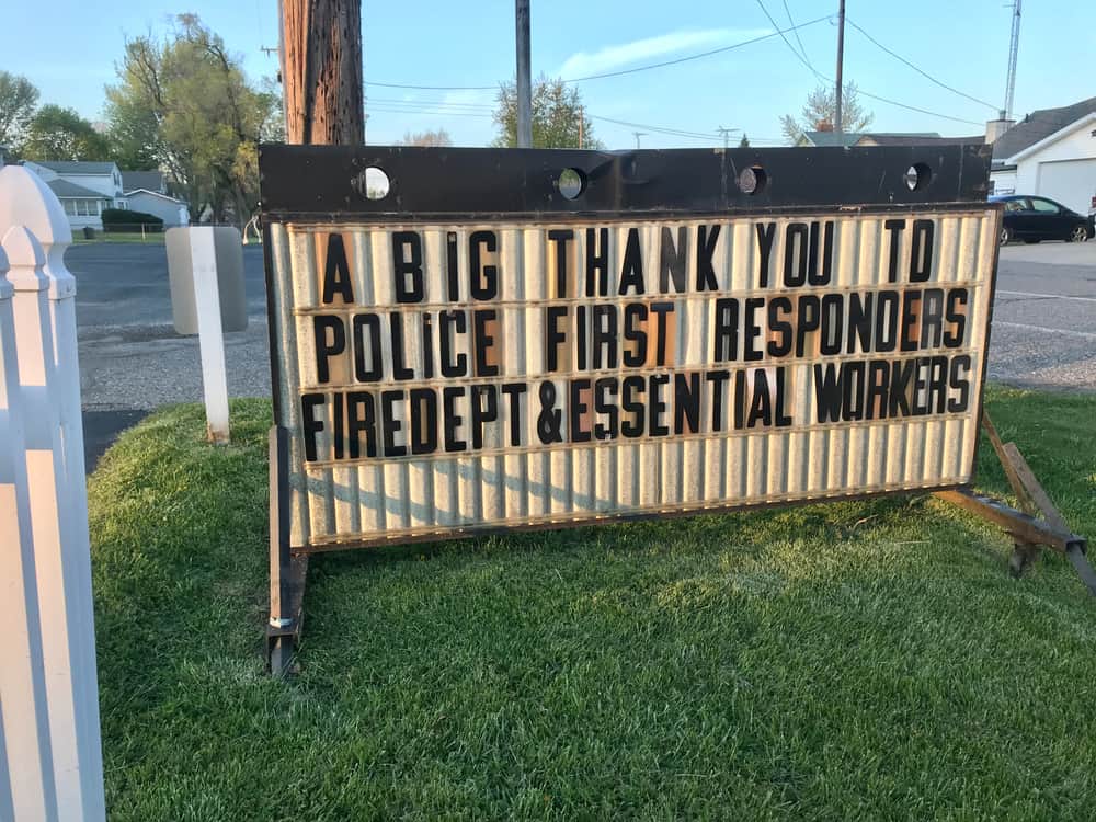 big sign saying thank you to police, fire department and essential workers